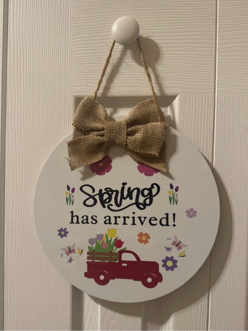 Spring Has Arrived Round Hanging Wall Sign - White with Burlap Bow